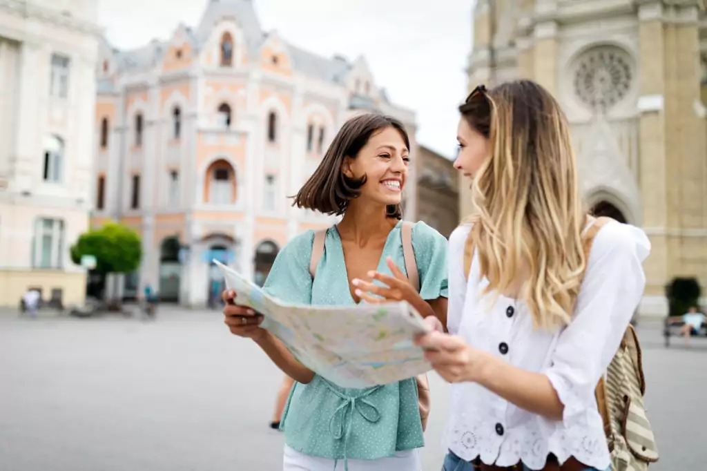 Happy traveling tourists sightseeing with map in hand