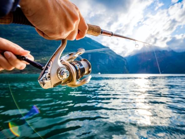 Woman fishing on Fishing rod spinning in Norway.